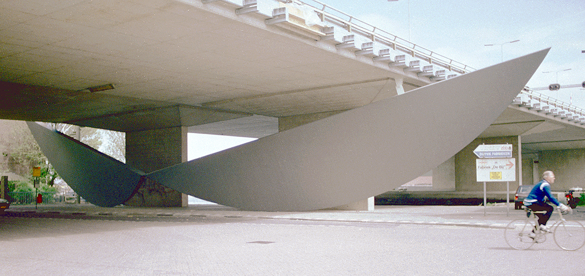 Original steel sculpture suspended beneath the viaduct in Koog aan de Zaan, where two large circular segments formed a spatial intervention between road, bridge and water.
